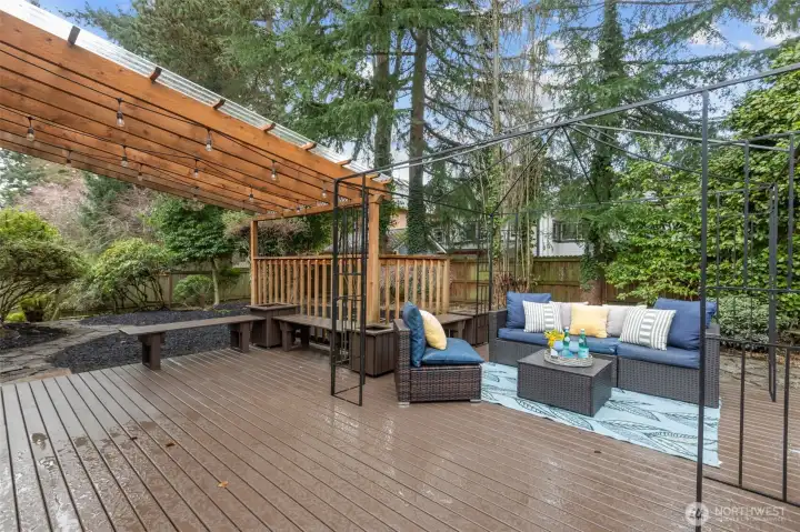 Private backyard retreat featuring expansive deck space and mature landscaping for added privacy.