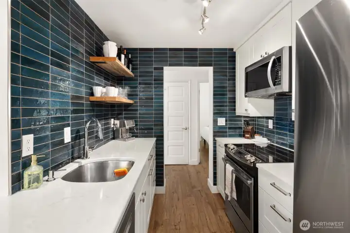 Custom open shelving! Modern blue tile backsplash accent is inspired by the color of Blue Skies & the waters of Elliott Bay!