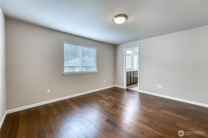 Primary Bedroom with Hardwood Floors.