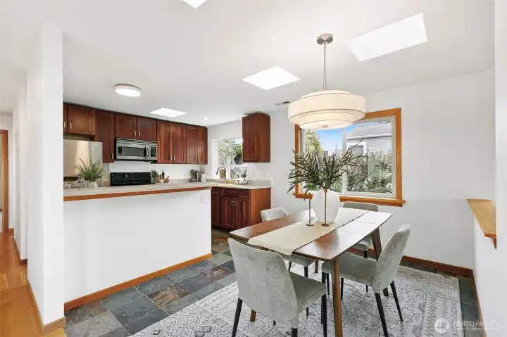 Thankfully the all-white-finishes era is out! Timeless are the warm wood tones paired with natural slate floors.