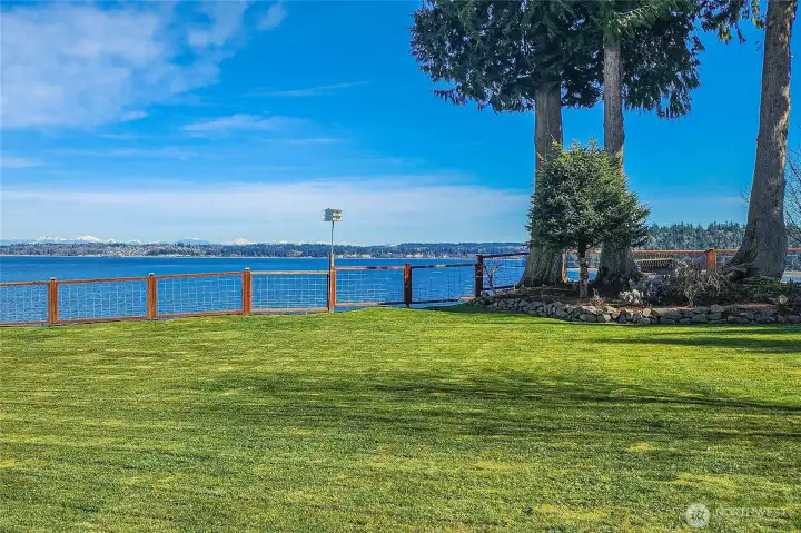 Stunning Hood Canal and Cascade Mountain views create an unforgettable backdrop from this spacious, level yard—perfect for outdoor living, entertaining, or quiet relaxation. With 202 feet of beautiful waterfront, the setting is truly exceptional.