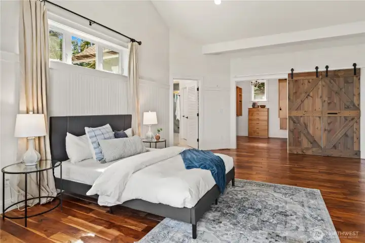 The spacious primary bedroom has a lovely walk-in closet, vaulted ceilings, propane fireplace, and 4-piece bath.