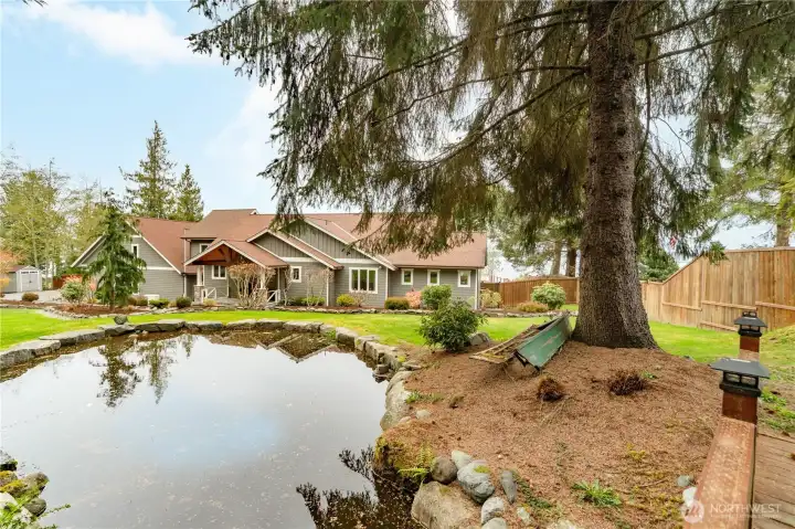 The back yard has a soothing waterfall and pond.