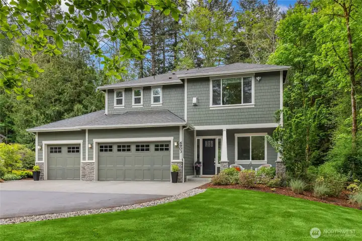 Set on 2.24 acres with beautiful landscaping and a backdrop of evergreens
