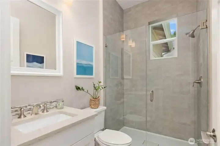 Main floor guest bath off mud room includes a shower