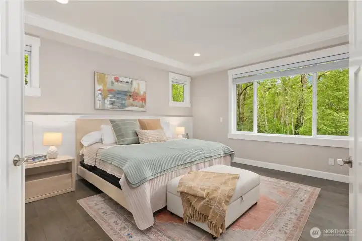 A calming, luxurious primary bedroom with French doors