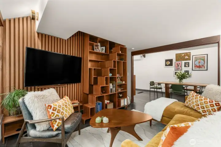 This custom built walnut bookcase opens and functions as the staircase to the upper loft