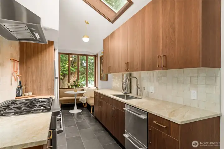 Custom built walnut cabinets, tile backsplash & 6-burner gas range