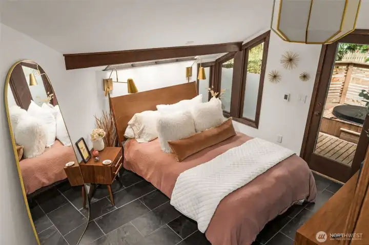 Spacious bedroom with heated floors and private deck with hot tub