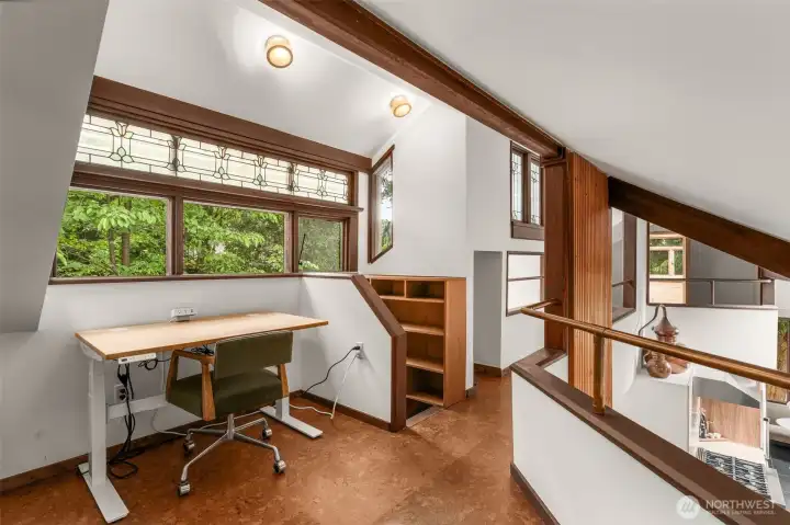 Loft space with cork floors & original stained glass window