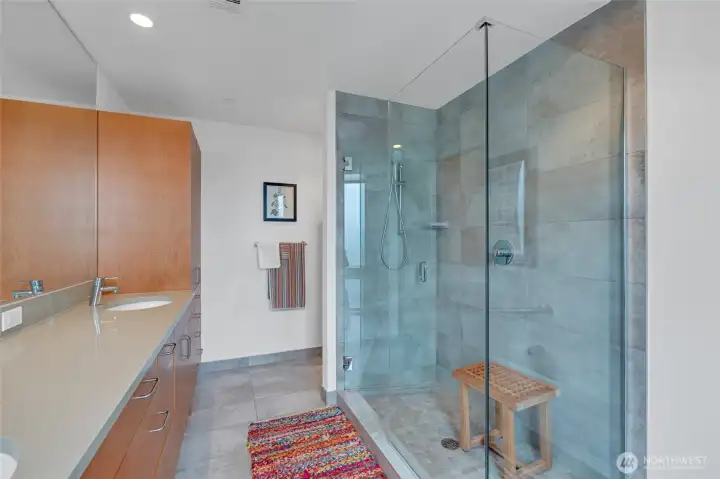 Primary bathroom with walk-in shower and custom cabinetry. Primary bathroom with walk-in shower and custom cabinetry.