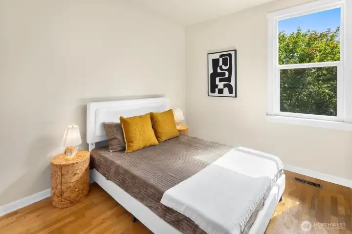 A second light-filled bedroom overlooking the surrounding greenery offers flexibility for guests, a home office, or everyday living. A second light-filled bedroom overlooking the surrounding greenery offers flexibility for guests, a home office, or everyday living.