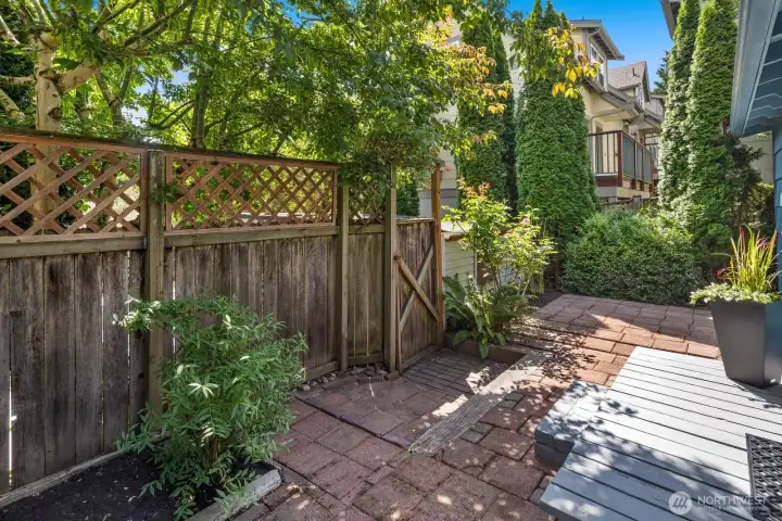 A fully fenced backyard offers a peaceful escape for morning coffee or gardening, private to the lower level unit. A fully fenced backyard offers a peaceful escape for morning coffee or gardening, private to the lower level unit.