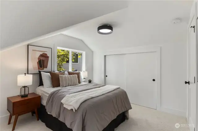 One of two upper level bedrooms offers tons of space and an extra reading or office nook.