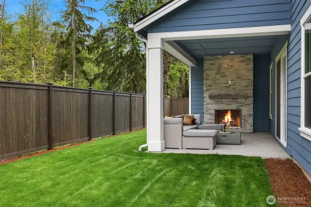 Covered patio and fenced in backyard
