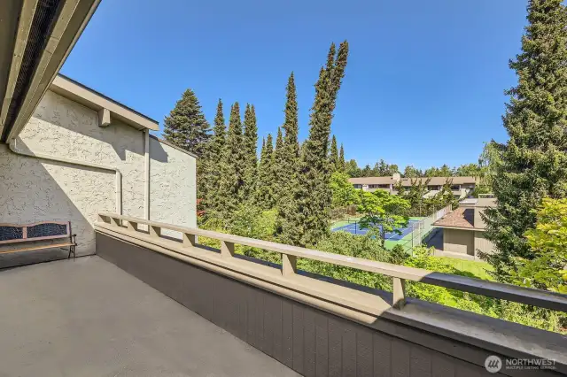 Unwind and gaze at endless skyline views from the vast private deck overlooking lush grounds, the pool, and the tennis court.
