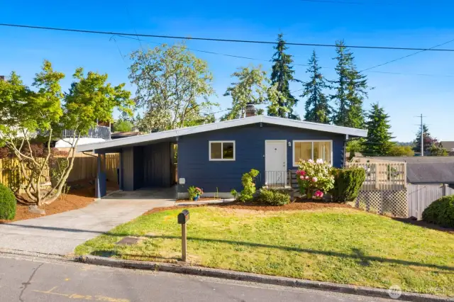 Long driveway, carport with two storage sheds