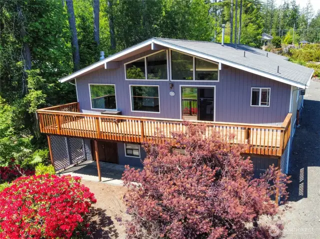 Welcome to Lake Limerick at 161 E Connemara Way! This 2nd fairway golf course home's exterior was just painted a nice darker gray. The sun reflection is indicating purplish. See the real color in the drone picture from behind the home. Very beautiful setting! Pacific NW natural landscaping envelopes this entire parcel. Easy yard maintenance. This 2000+ SF floor plan could even accommodate an AirBnB having a finished basement you could rent out while occupying the main floor. Lower basement is plumbed in an area it would be easy to put in a small kitchen unit.