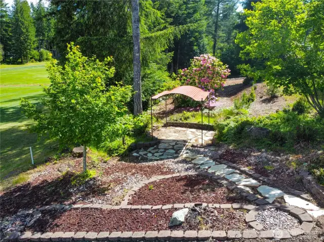 Covered gazebo area & campfire area nestled between lower patio & golf course.