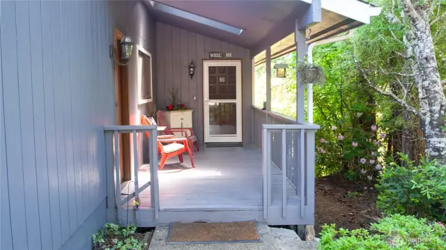 Shady covered Front porch. This area stays cool due to the side flora that offers plenty of privacy.
