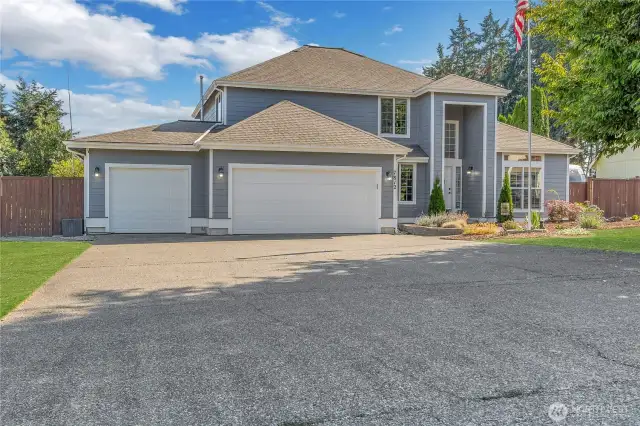 3 car garage with plenty of parking. Grass is enhanced