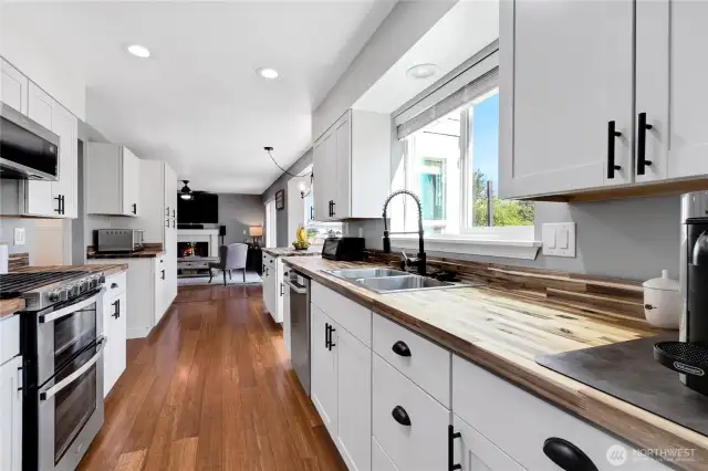 New white cabinets with new hardware and butcher black counters. New lighting.