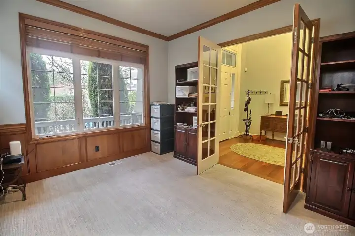 French doors open into this well-appointed Office with dark wainscotting and trim throughout.