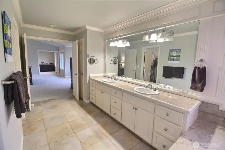 Primary Bath looking out to the Primary Bedroom. Walk In Closet is within bath area.