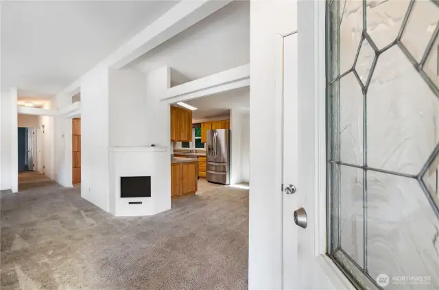 Enter into the living room, where natural light and a welcoming atmosphere greet you.