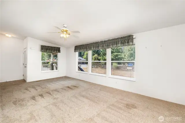 The living room boasts vaulted ceilings and large windows, creating a bright and airy feel.