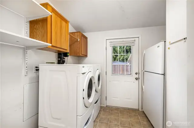 Sizable laundry room with plenty of storage space and direct access to the yard.