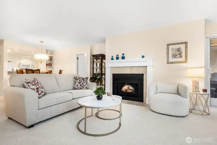 A corner fireplace and soft neutral palette make this space both bright and welcoming.