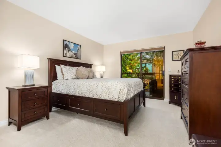 The primary bedroom offers restful comfort with tree views and room for full-size furniture.
