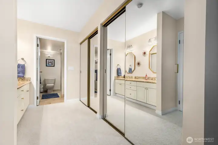 Primary suite entry with dual mirrored closets leading to an updated bath.