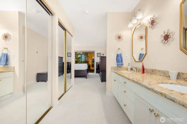 Primary suite entry with dual mirrored closets leading to an updated bath.