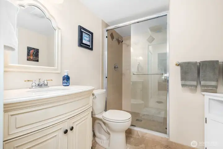 Walk-in shower with tile surround and built-in niche offers a spa-like experience.