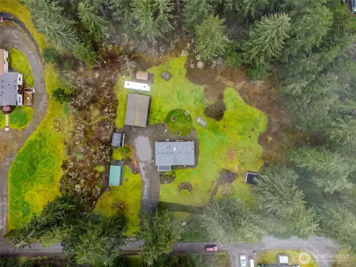 2.49 Acres featuring detached garage, RV Parking, outbuildings, and a firepit.