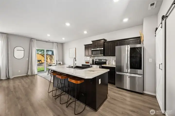 Kitchen with stainless steel appliances, walk-in pantry