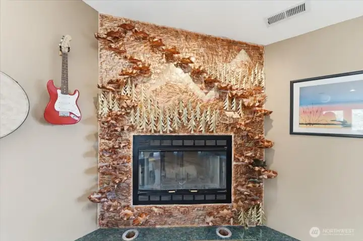An artistic fountain encircles the wood-burning fireplace, creating a striking third-floor focal point.