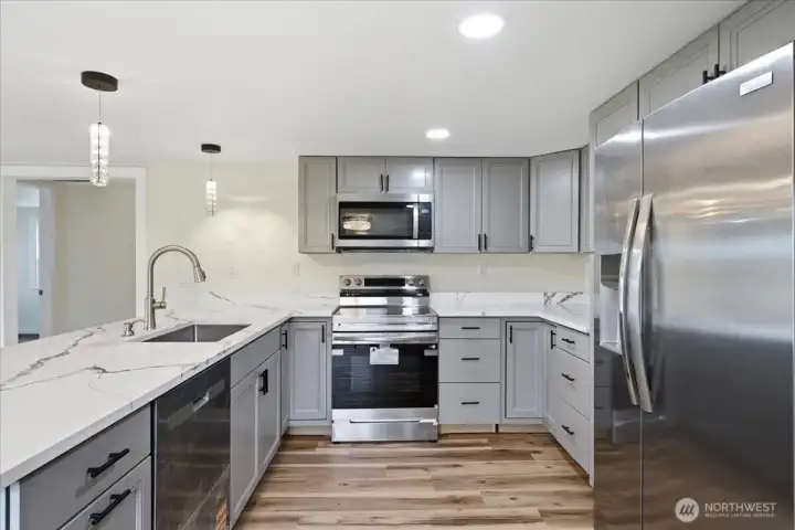 Open concept kitchen with quartz counters