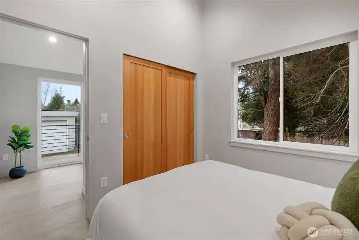 Surrounded by trees, this bedroom feels like you are up in a treehouse.