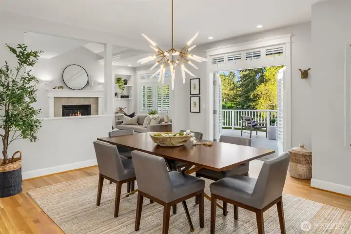The dining area looking out to the back deck. All of the living spaces have warm hardwood floors.
