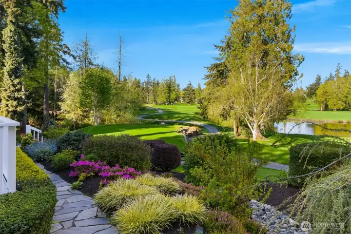The grounds on this 1/4 acre lot have been professionally planted and maintained. A flagstone walkway wraps around the property and steps lead off the back deck for direct access to the golf course.
