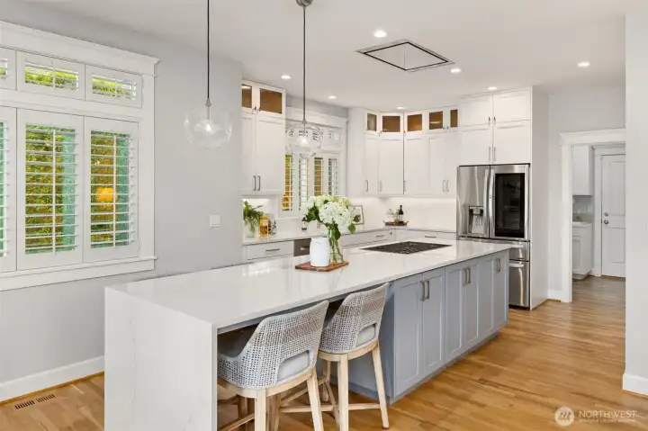 This modern kitchen was designed by Kim McCall Designs to be both beautiful and functional. The quartz infinity eat-in bar is the perfect spot to enjoy coffee while you plan your day.