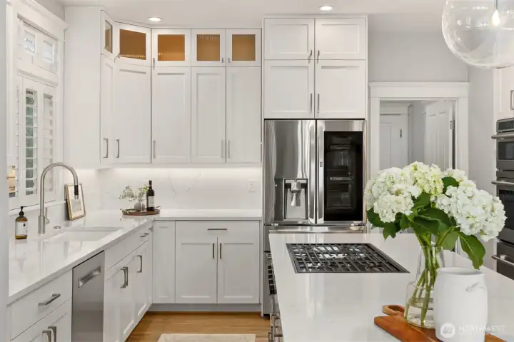 Floor to ceiling cabinetry, updated modern appliances including a Wolf propane cooktop and a sleek concealed Falmec exhaust vent. This kitchen has great style, but it was also built with the serious home chef in mind.