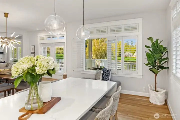 Looking out from the bar to the covered area on the deck. The entire home has plantation shutters for nice privacy.