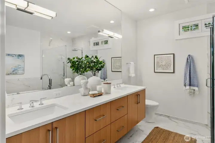 The fully updated primary bathroom is a true retreat.