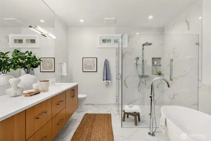 Lined in marble with dual sinks, quality wood cabinetry, a soaking tub, oversized shower and heated floors– every detail here was thought of.