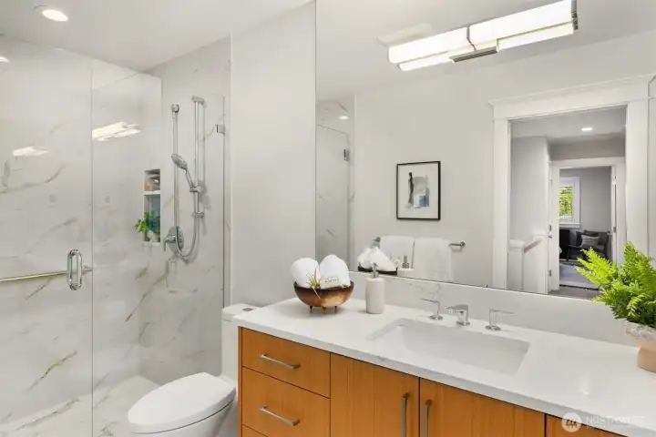 Upstairs there are two bathrooms. This is the main bathroom off of the hallway. It has been fully updated in the same great style as the primary and half bathrooms.