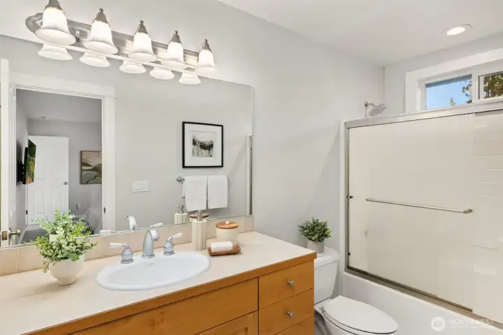 The attached full private bathroom with a tub and shower combo.